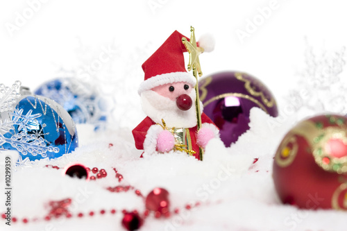 santa claus with christmas balls on snow