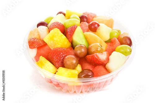 Bowl of colorful  delicious fruit salad isolated on white.