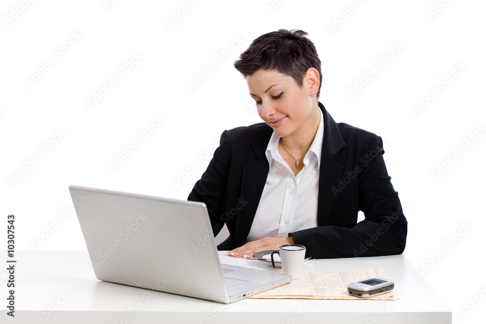 Businesswoman working at desk, isolated on white. Businesswoman working at desk, isolated on white.
