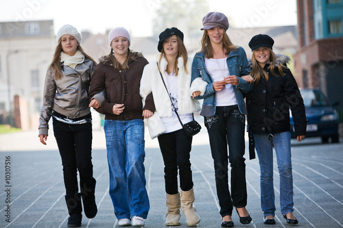 A group of teenage walking towards the camera