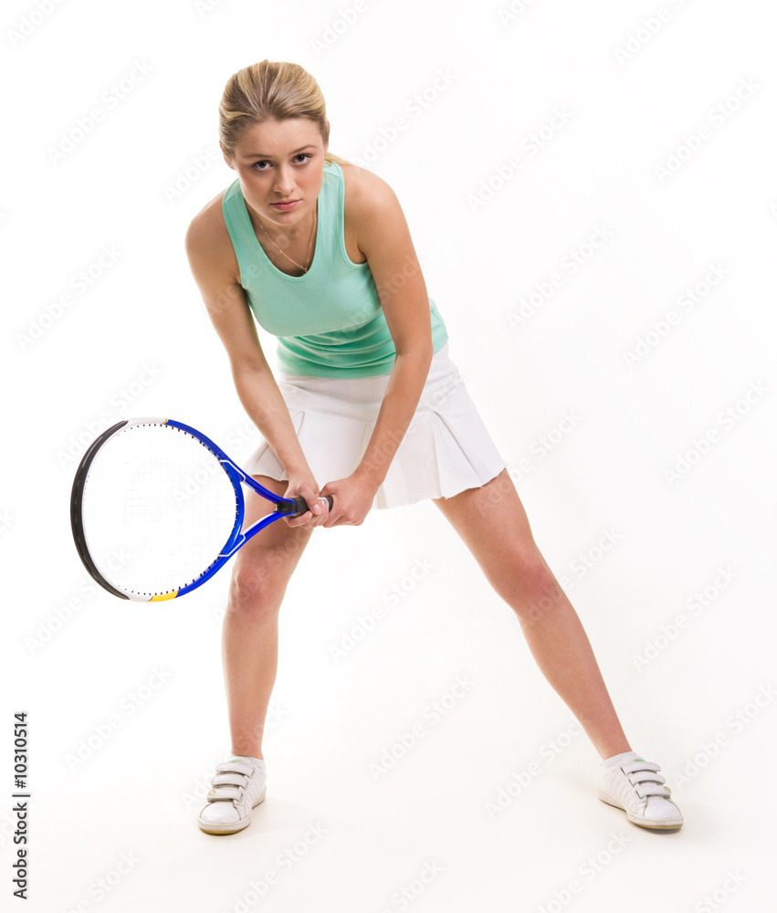 Serious woman with tennis racquet looking straight Serious woman with tennis racquet looking straight