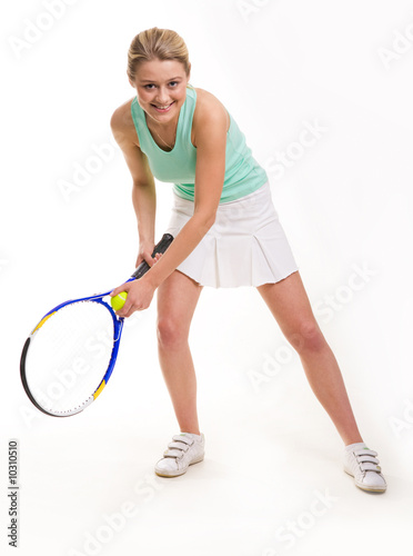 Successful tennis player bent ready to serve ball © pressmaster