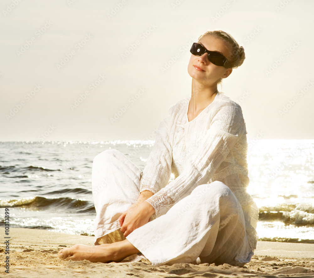 Beautiful young woman relaxing on a beach