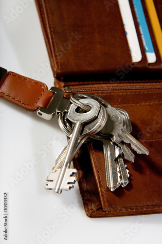 bunch of keys on brown leather wallet