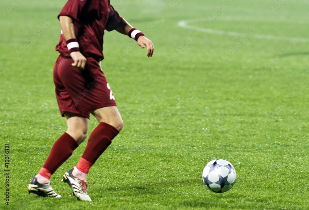 Soccer player running after the ball Soccer player running after the ball