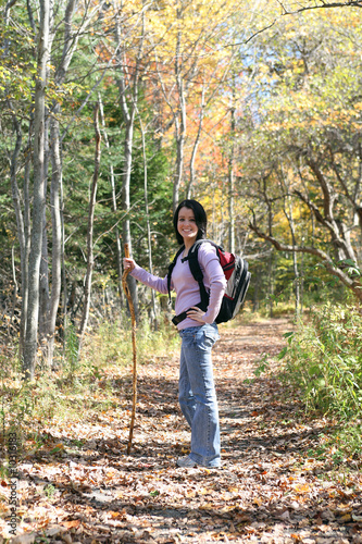 pretty teenage girl hiking outside in the fall