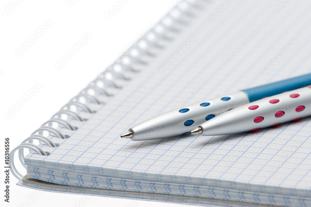 Pen and paper on a white background