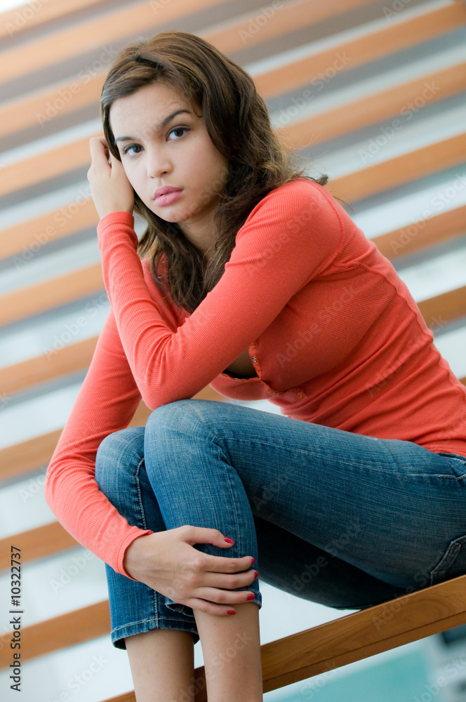 A lifestyle shot of a woman at home on the stairs A lifestyle shot of a woman at home on the stairs