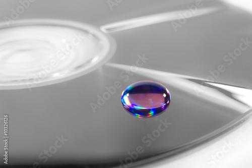 Multicolored beautiful drop of water on a B&W surface