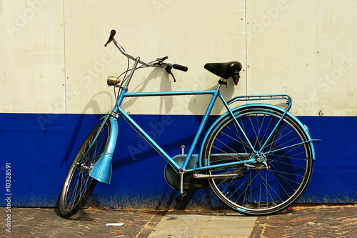 Abandoned bike in front of a painted wall