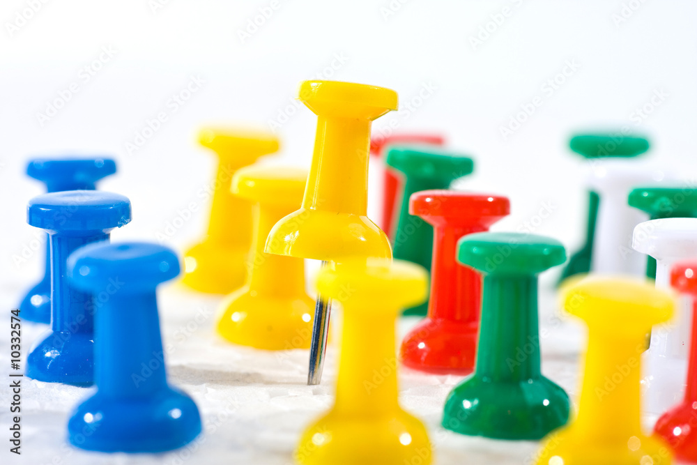 group of colorful office pins on white background group of colorful office pins on white background