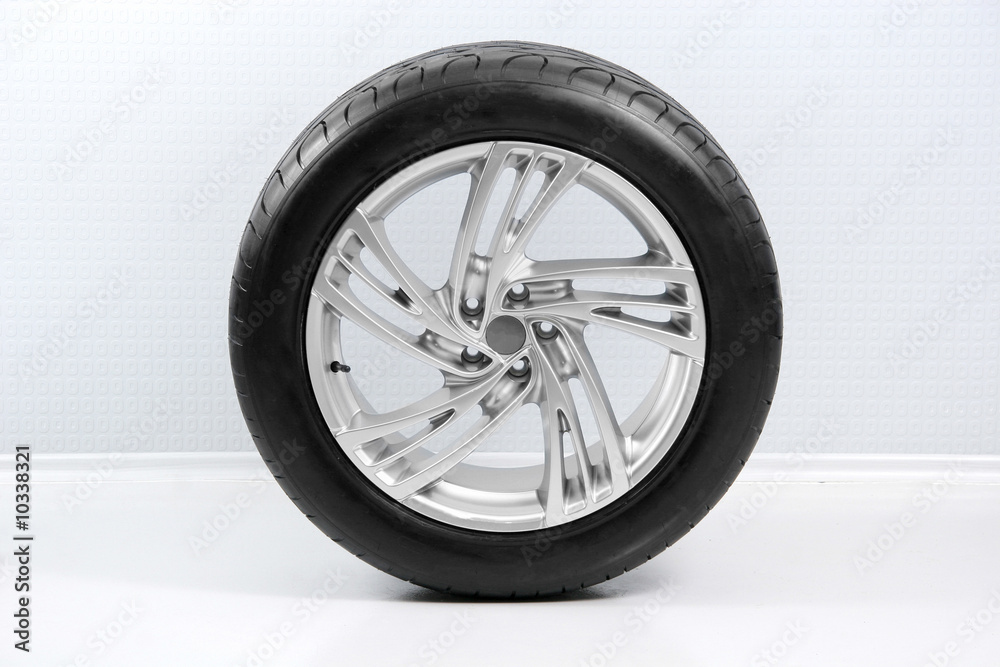 Wheel with steel rim over the white wall Wheel with steel rim over the white wall