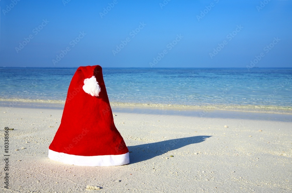 Christmas hat on a white sandy beach in the Indian Ocean Christmas hat on a white sandy beach in the Indian Ocean