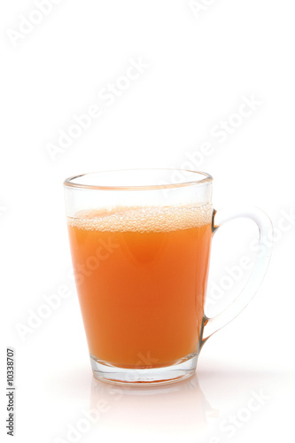 little transparent glass with orange juice