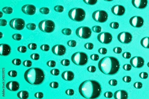Abstract background with water drops on green glass