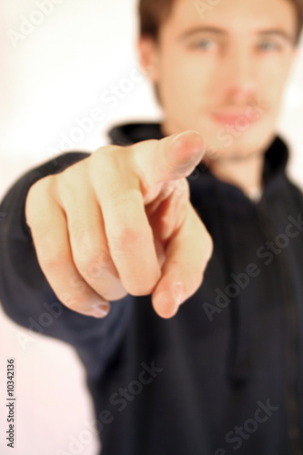 A young man indicating on white background