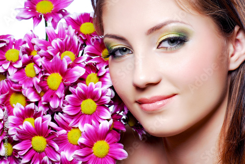 Beutiful girl face with pink flowers.