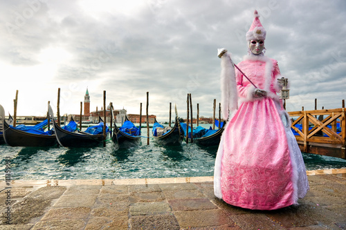 mask and gondolas in Venice, Italy.