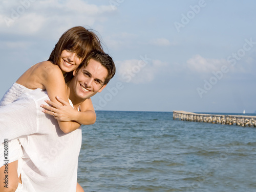 young couple, piggyback fun on vacation