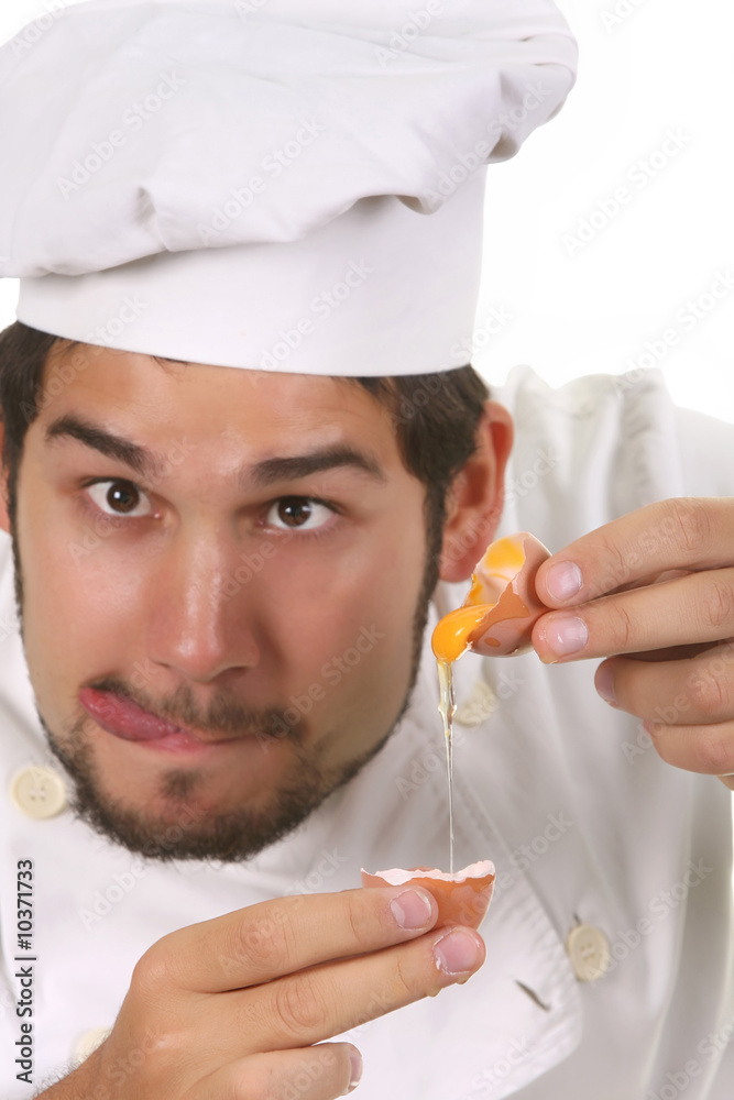 young funny chef cracking an egg, focus on egg young funny chef cracking an egg, focus on egg