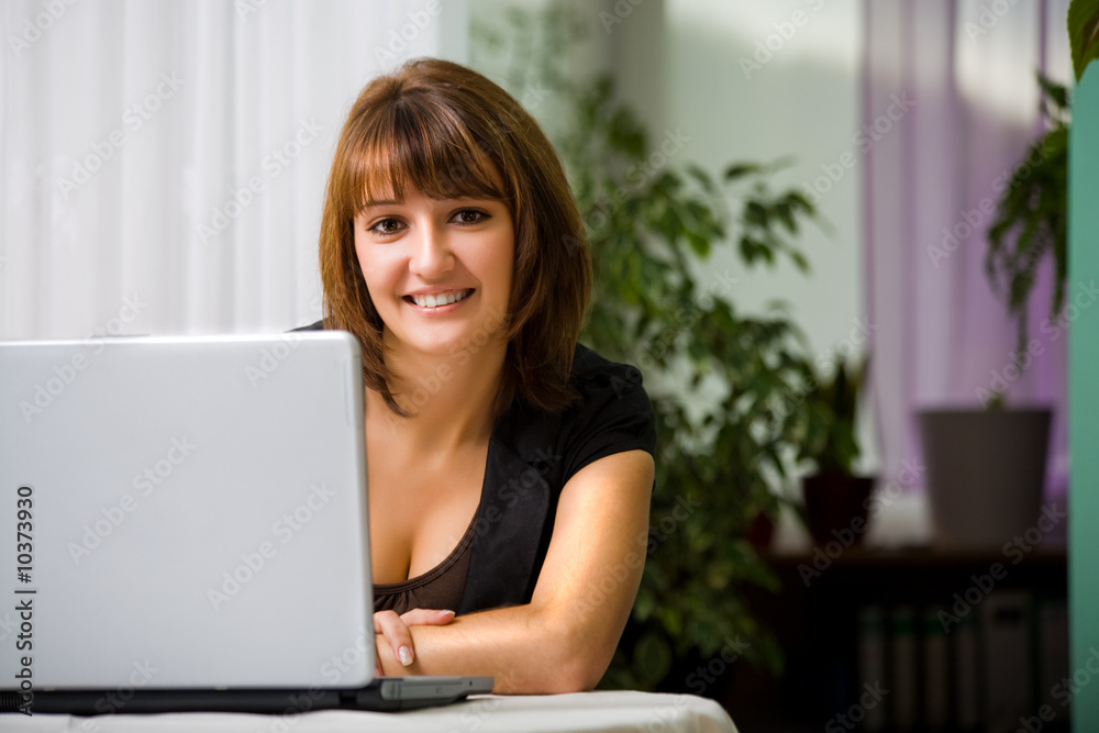 young woman with a laptop in the living room young woman with a laptop in the living room