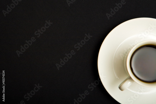 Above view of cup of strong coffee over black background