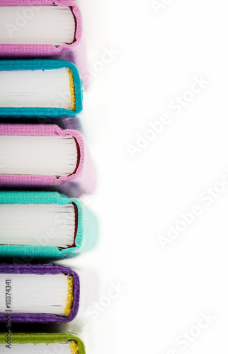 Bilde på lerret High pile of books or notepads in colorful covers