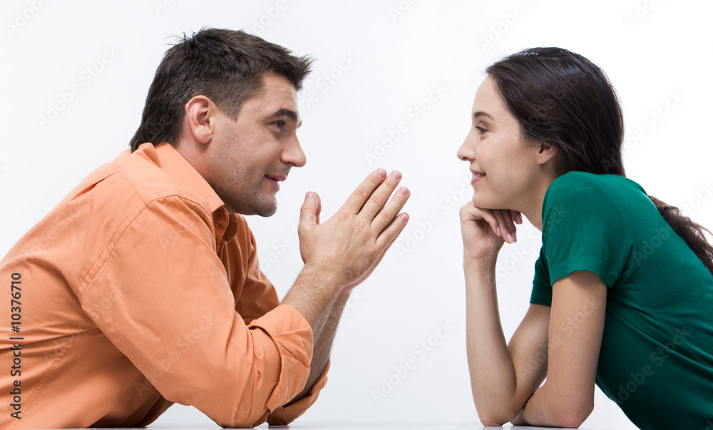 Happy couple having conversation face to face Happy couple having conversation face to face