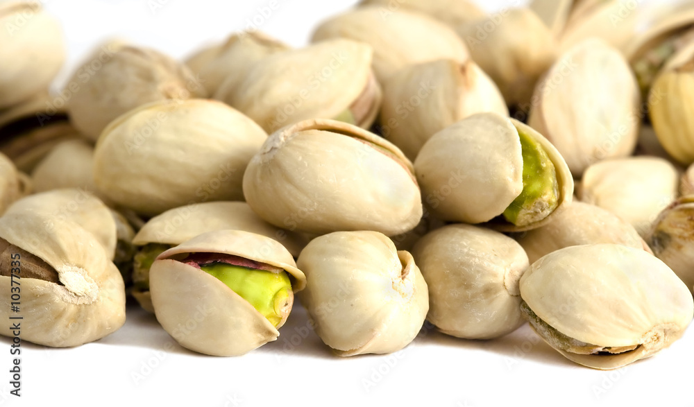 Roasted and salted pistachios on white background Roasted and salted pistachios on white background
