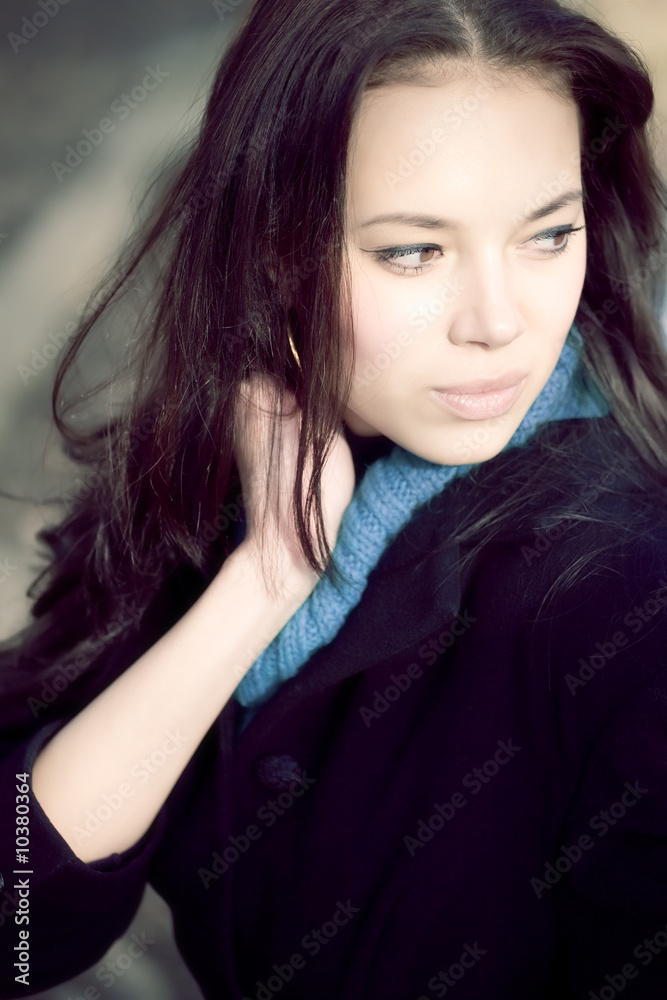 Young woman outdoors portrait. Soft blue tint. Young woman outdoors portrait. Soft blue tint.