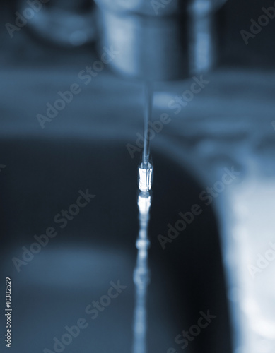 water flowing from a tap focus of the waterdrops photo