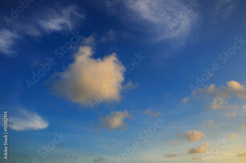 Detail of tropical sky with soft sunset colored clouds