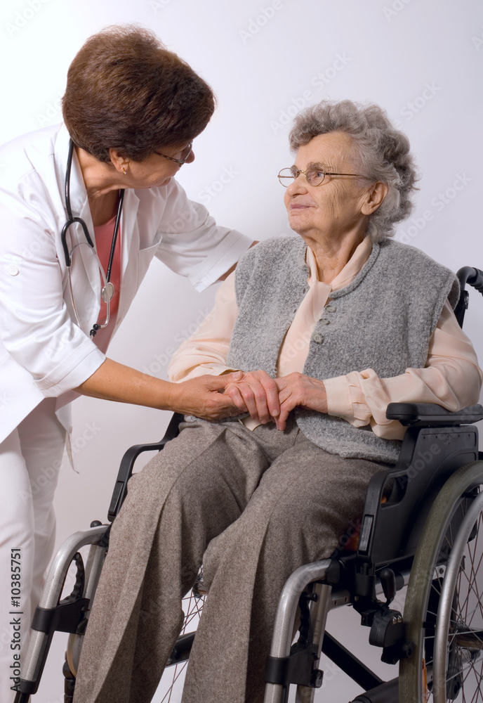 Health care worker and elderly woman in wheelchair Health care worker and elderly woman in wheelchair