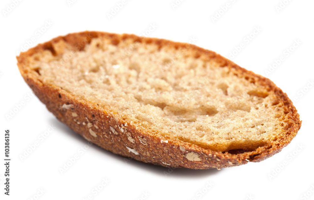 crust of whole wheat bread on light background crust of whole wheat bread on light background