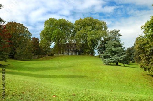 Summer park and gardens of large old house.