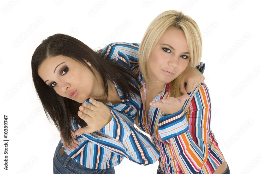 Female Caucasian friends acting silly blowing kisses