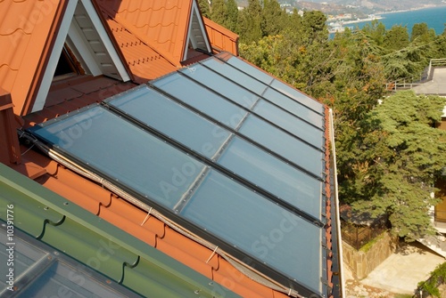 Alternative energy- solar system on the house roof. photo