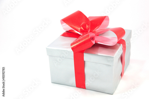 Silver gift box with red bow isolated on white