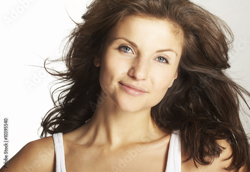 A happy young woman with facial expression on white background