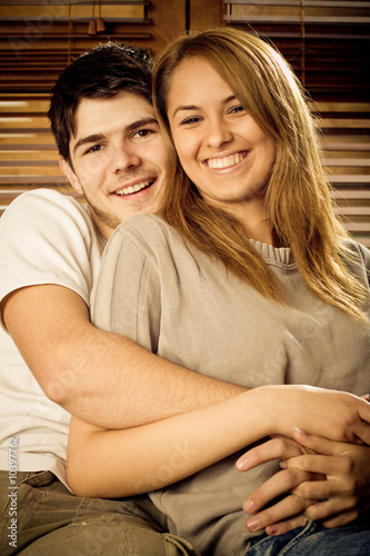 Happy young couple having fun on the sofa