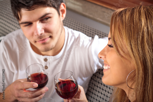 Happy young couple drinking wine