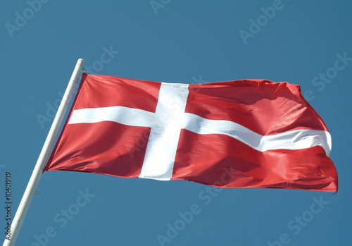 Denmark or danish flag waving on blue sky