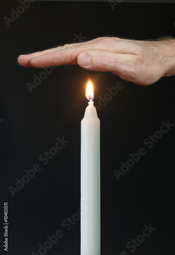 hand over flame of candel
