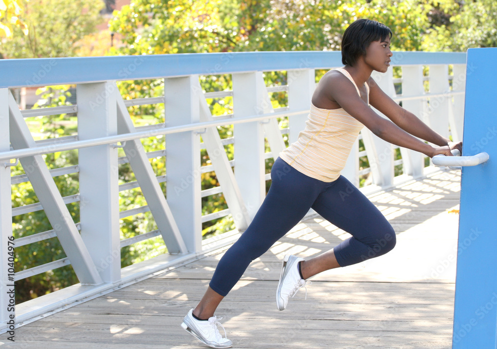 African-American female exercising, stretching, outdoors African-American female exercising, stretching, outdoors