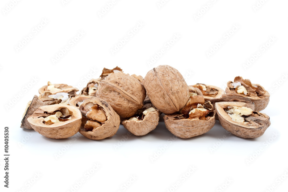 Cracked and whole walnuts isolated on the white background Cracked and whole walnuts isolated on the white background