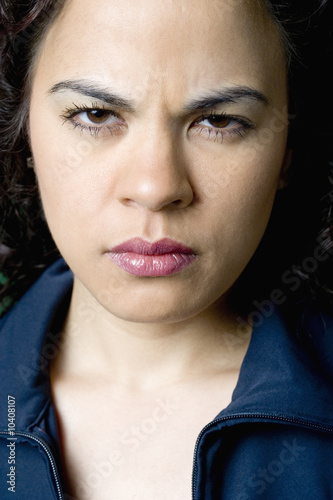Portrait of a young Latino woman with an angry look