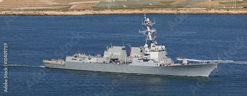 Arleigh Burke-class guided missile destroyer leaving port.