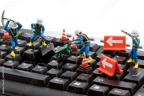 computer repair concept - workers repairing keyboard