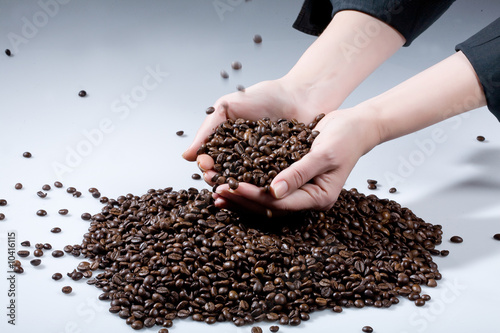 Woman s hands and coffee beans