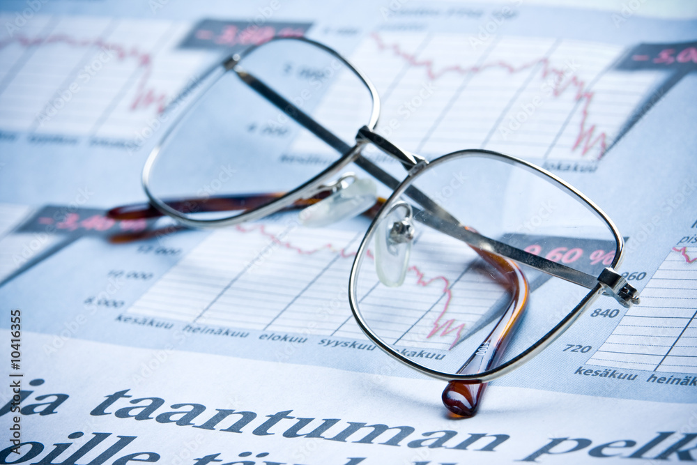 glasses on financial diagram. business concept glasses on financial diagram. business concept